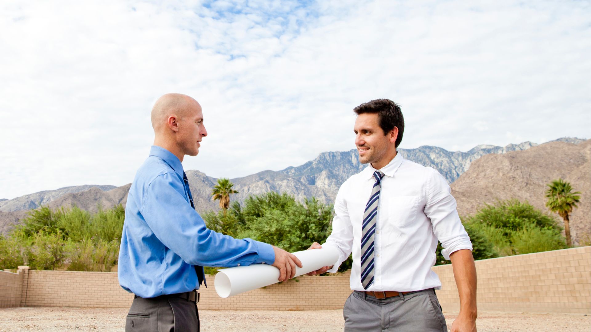people shaking hands outside